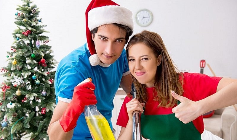 young couple preparing their house for christmas