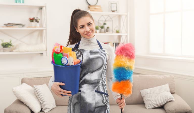 Woman holding a blue basket filled with tools and smiling