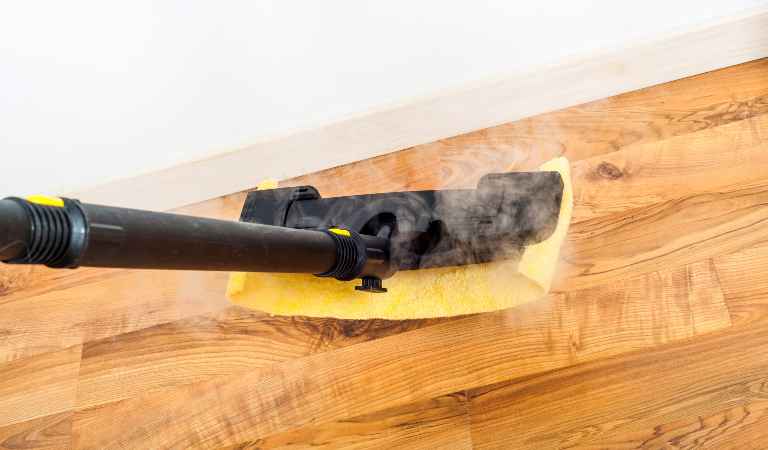 Wooden, parquet, laminate floors cleaning with steam in the room.