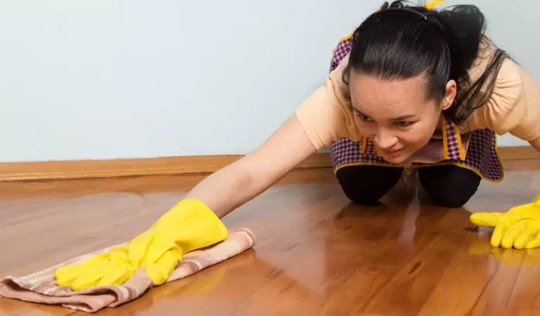 woman cleaning Vinyl Plank floorings