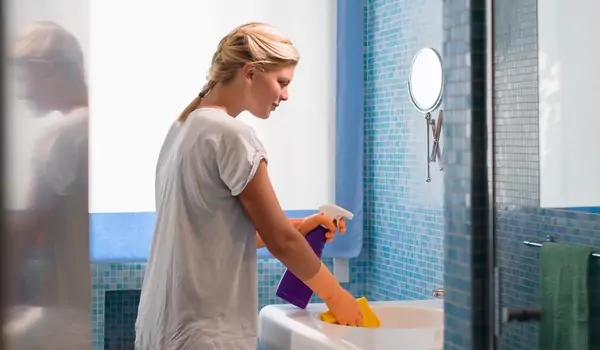 woman cleaning a bathroom