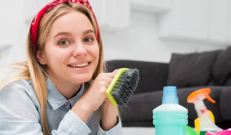 woman with some cleaning supplies