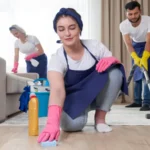 Professional cleaning service team cleans living room in modern apartment