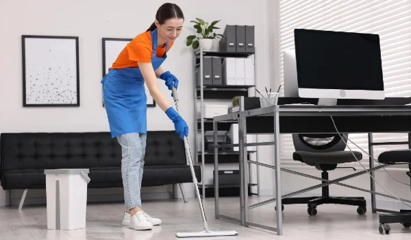 Cleaning service woman washing floor with mop in office