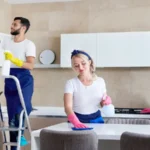 Cleaning service team at work in kitchen in private home